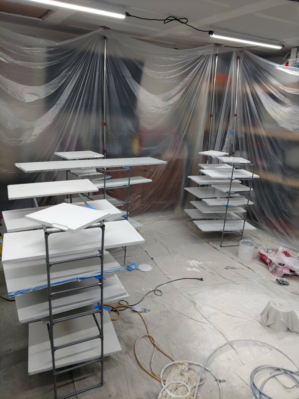 White cabinet doors drying in spray booth
