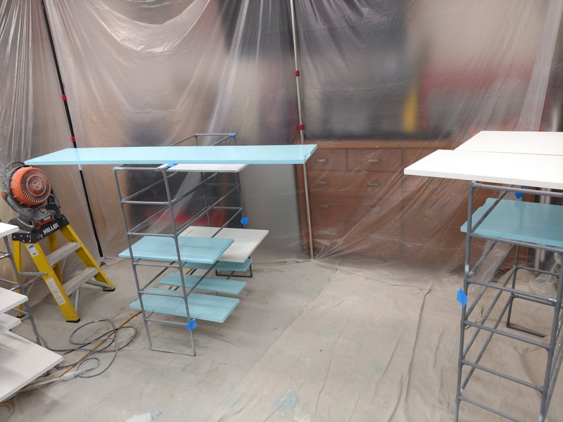 Blue and white cabinet parts drying with fan