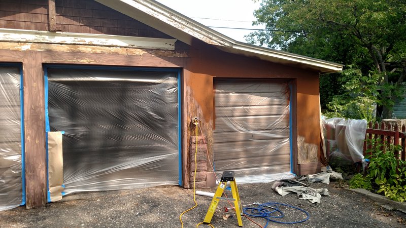 Garage with peeling paint and masking in place