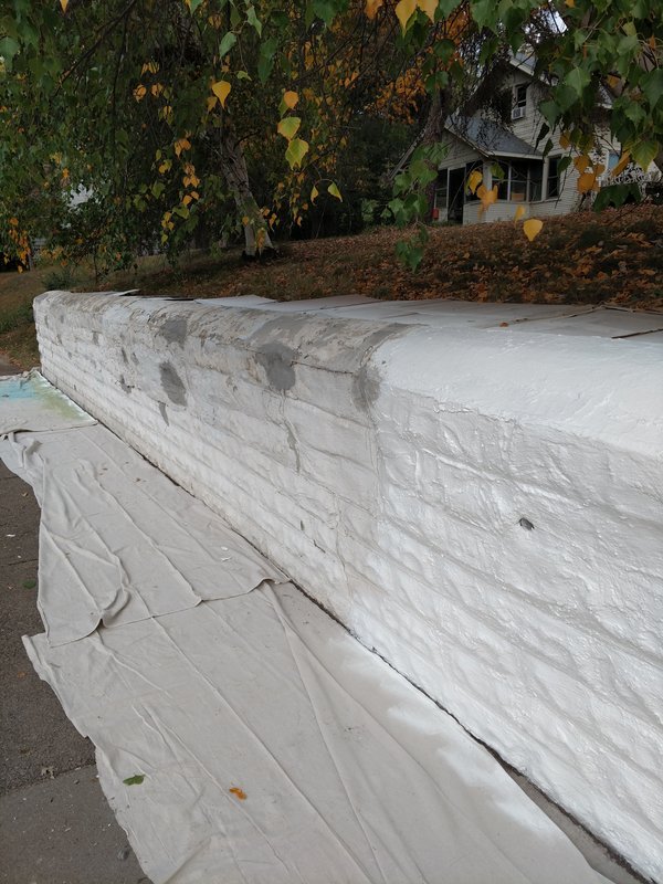 Wall partially painted showing before and after contrast